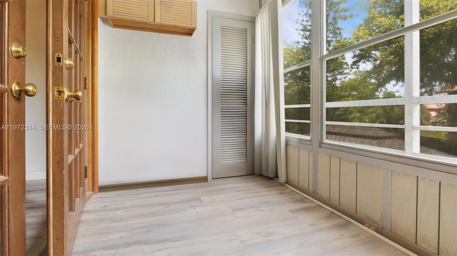 8605 West Sample Road, Unit 202 Coral Springs, FL 33065 - Photo 8 of 26 a view of a bathroom with a glass door
