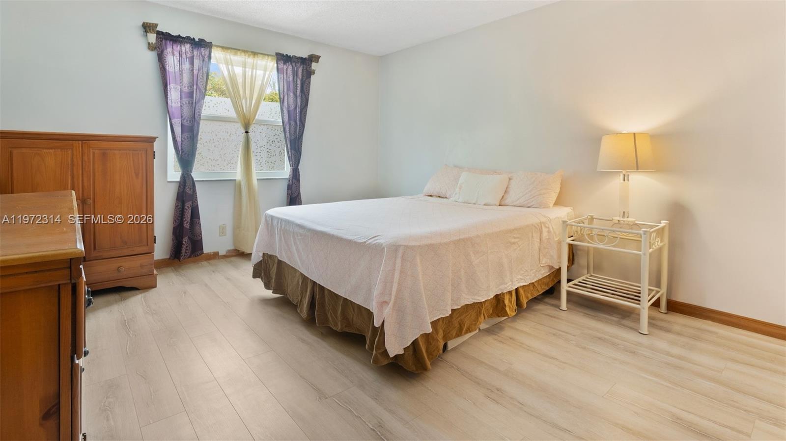 8605 West Sample Road, Unit 202 Coral Springs, FL 33065 - Photo 10 of 26 a bedroom with a bed and a window