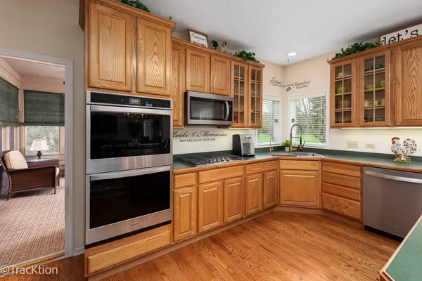 a kitchen with stainless steel appliances granite countertop a stove microwave and cabinets