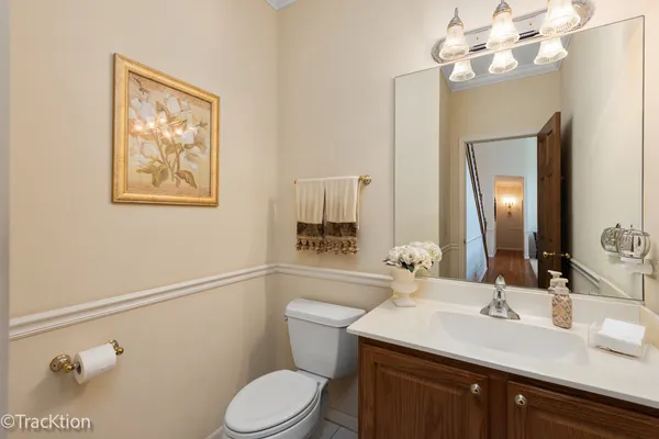a bathroom with a toilet a sink and mirror