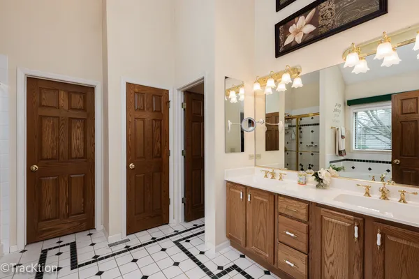 a bathroom with a double vanity sink and a mirror