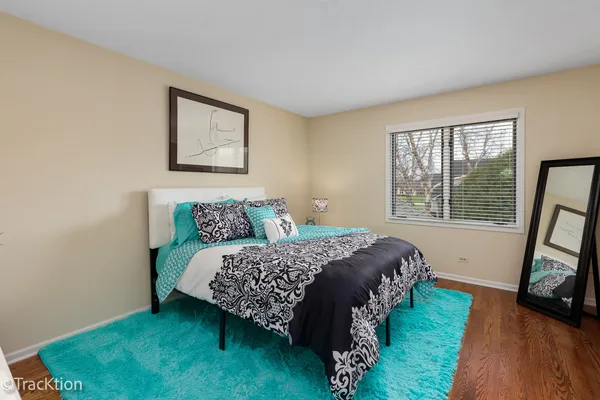 a bed sitting in a bedroom next to a window