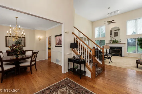 a dining room with furniture a chandelier and wooden floor