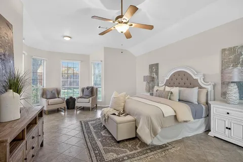 a bedroom with a bed couches and white walls