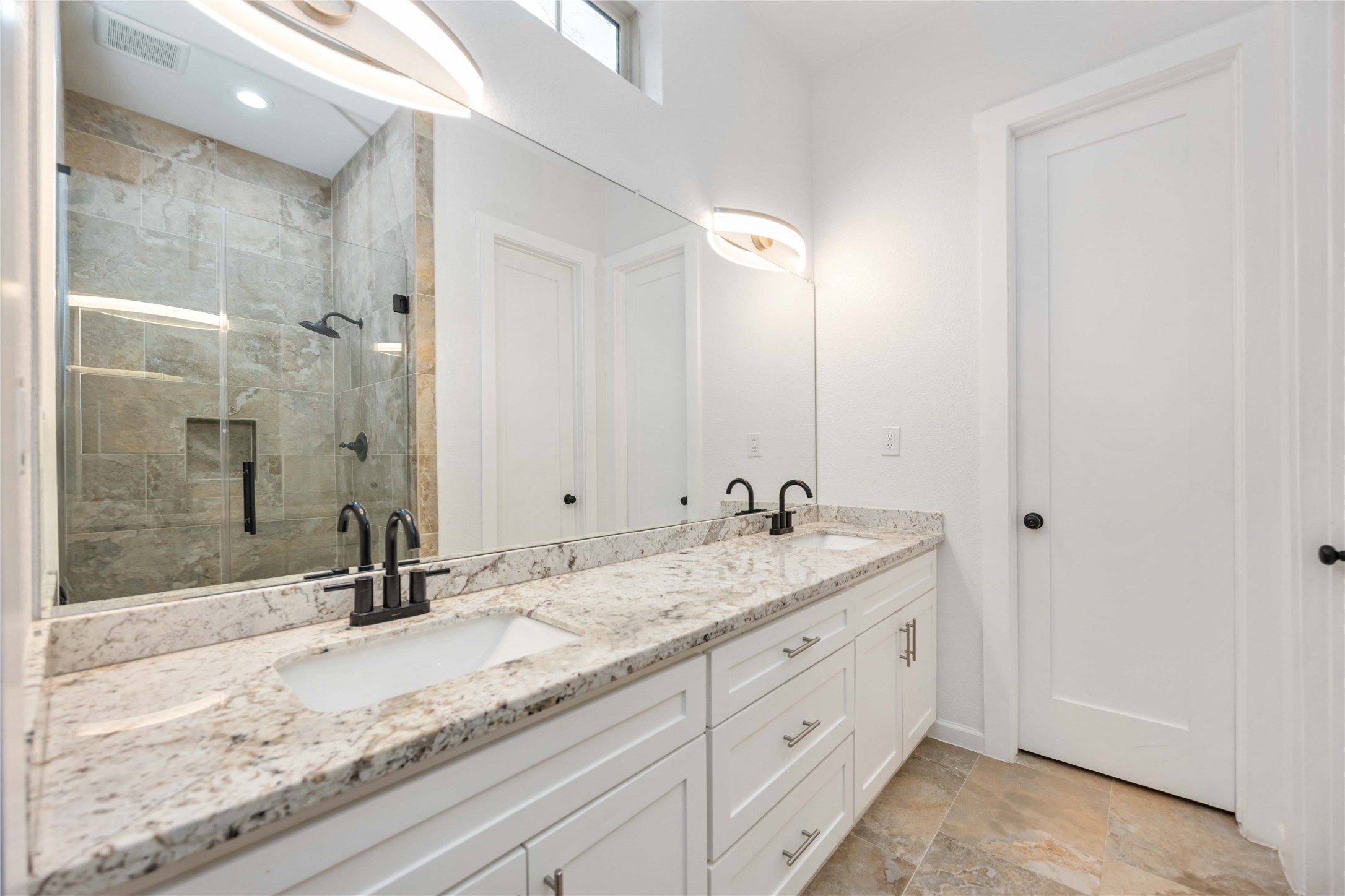14108 Bridgeport Road, Unit B Houston, TX 77047 - Photo 14 of 24 a bathroom with a granite countertop sink and a mirror