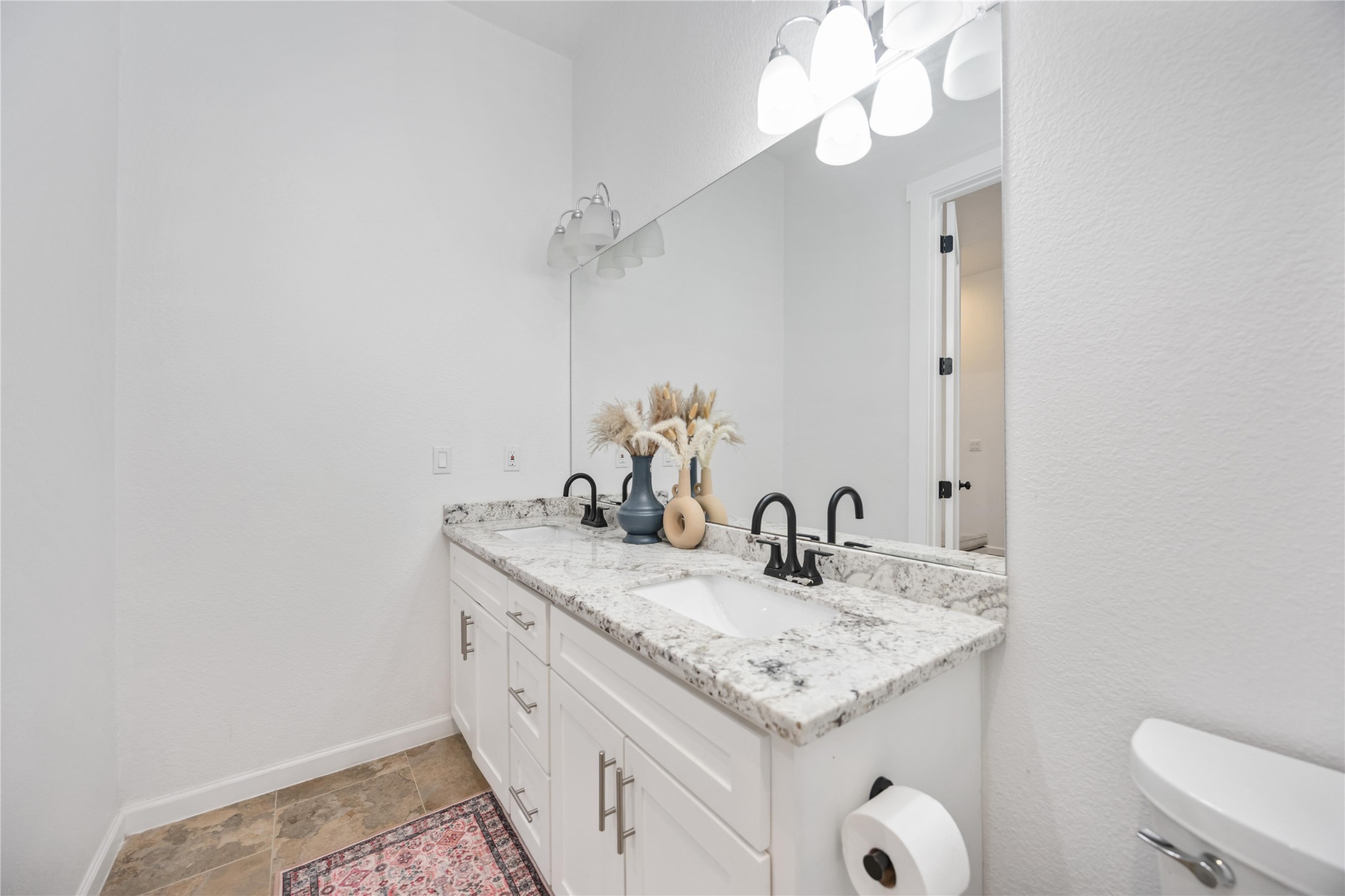 14108 Bridgeport Road, Unit B Houston, TX 77047 - Photo 18 of 24 a bathroom with a granite countertop sink and a mirror