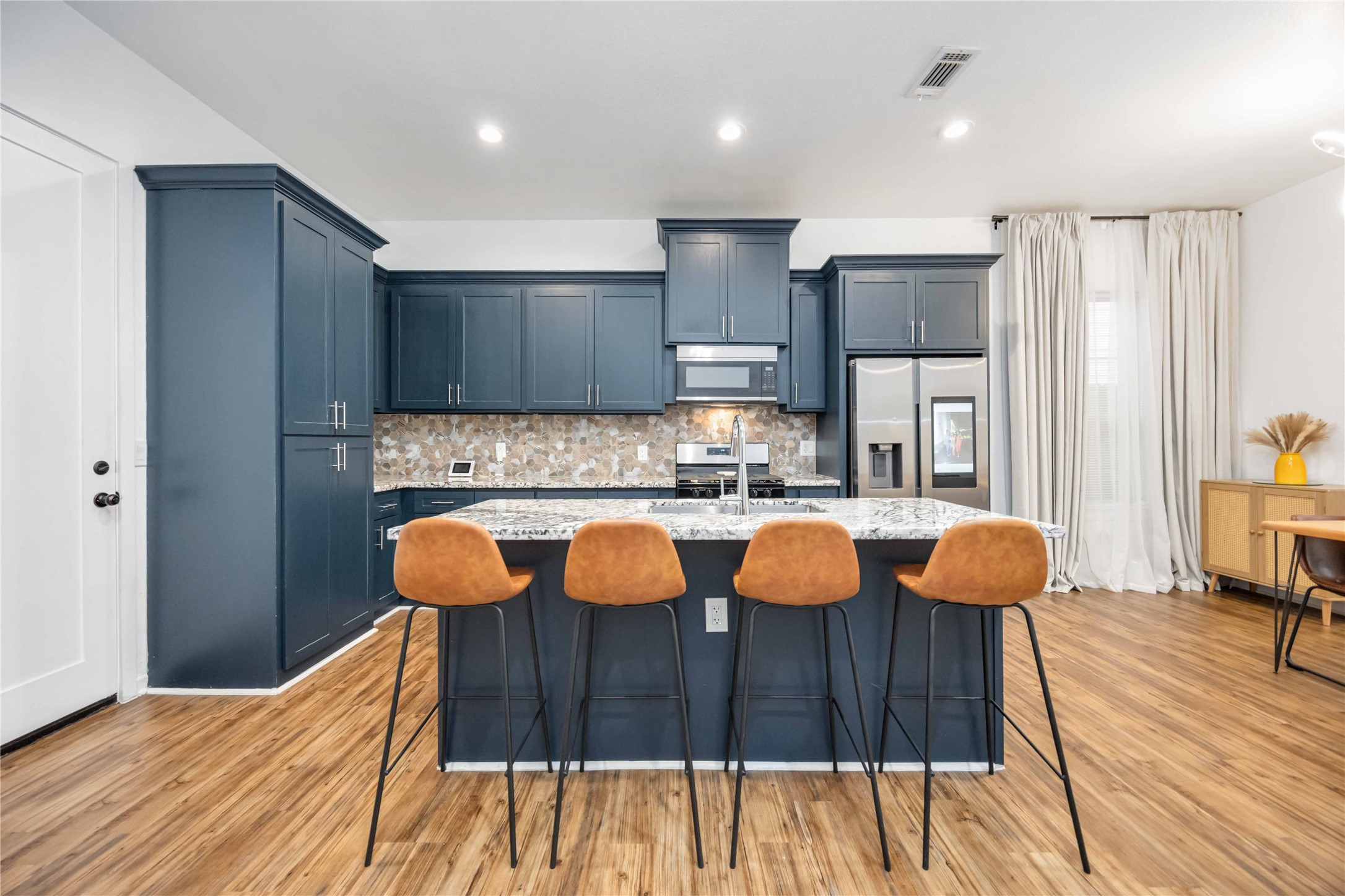 14108 Bridgeport Road, Unit B Houston, TX 77047 - Photo 4 of 24 a kitchen with stainless steel appliances granite countertop a sink and a refrigerator