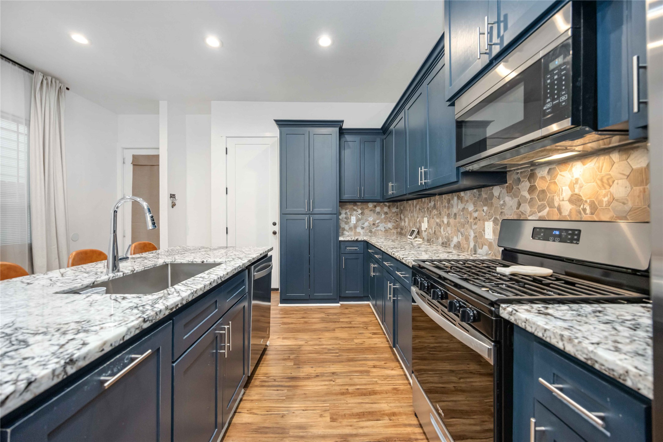 14108 Bridgeport Road, Unit B Houston, TX 77047 - Photo 6 of 24 a kitchen with kitchen island granite countertop a sink stove and cabinets