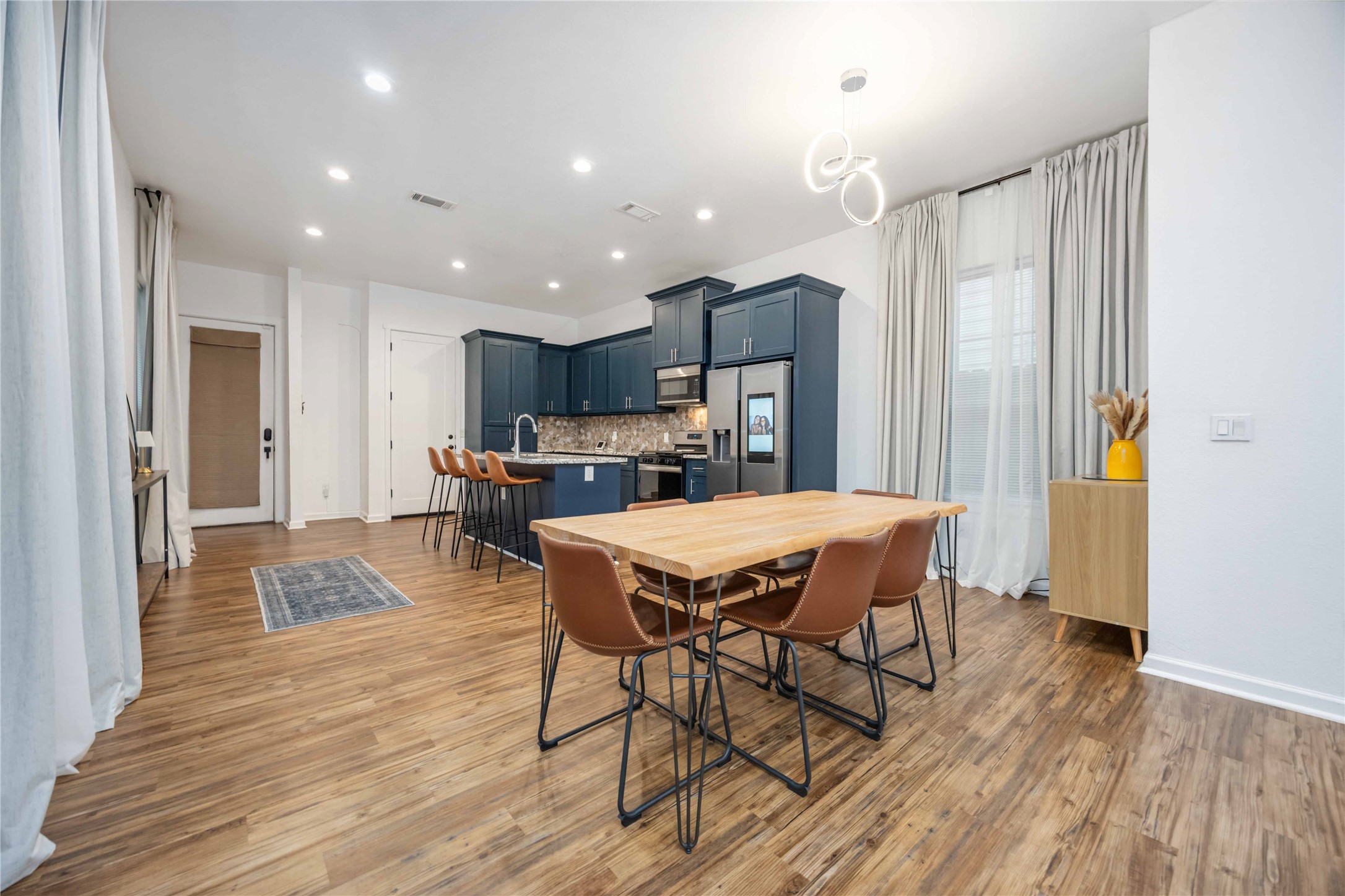 14108 Bridgeport Road, Unit B Houston, TX 77047 - Photo 8 of 24 a dining hall with stainless steel appliances granite countertop a table chairs and a refrigerator