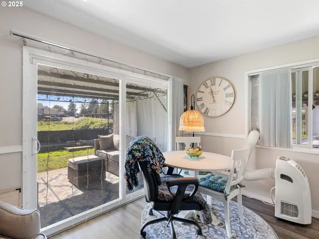 a dining room with furniture a rug and a large window
