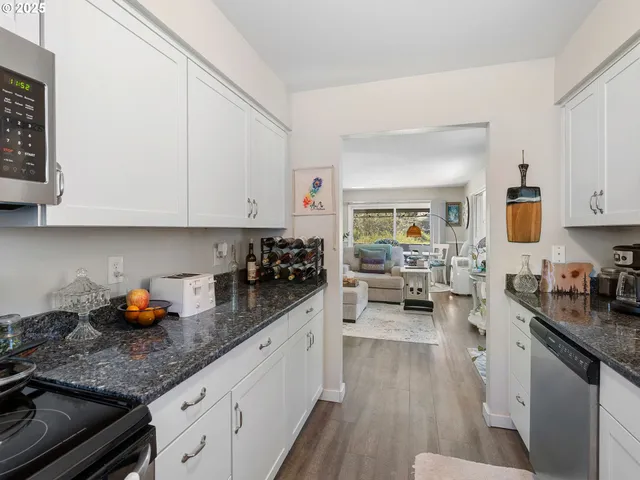 a kitchen with sink cabinets and stove top oven