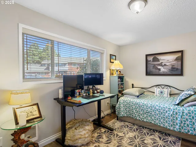 a bedroom with bed couch and window