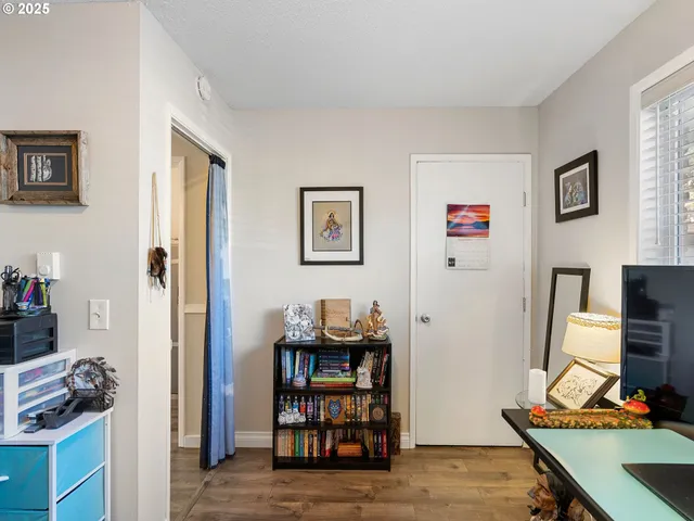 a view of a workspace with furniture and a window
