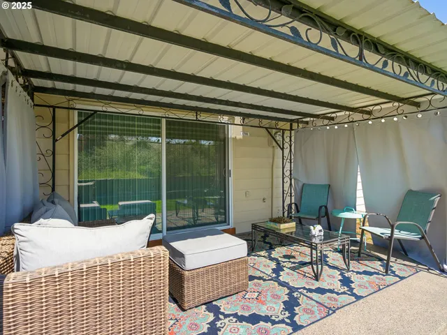a balcony with furniture and a potted plant