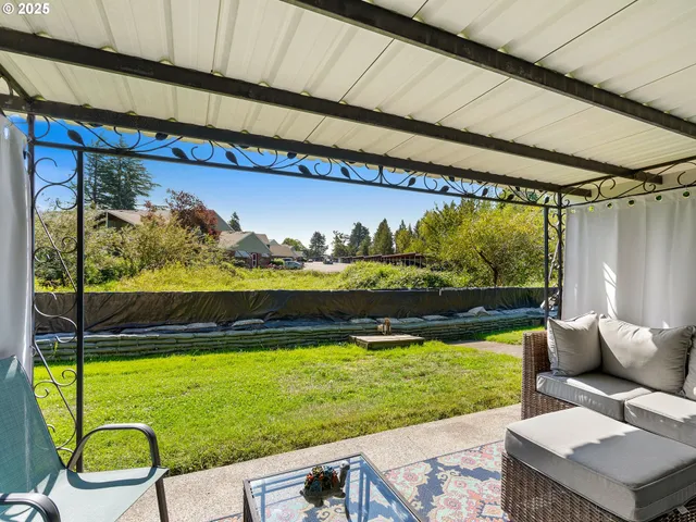 a view of a chairs and table in patio