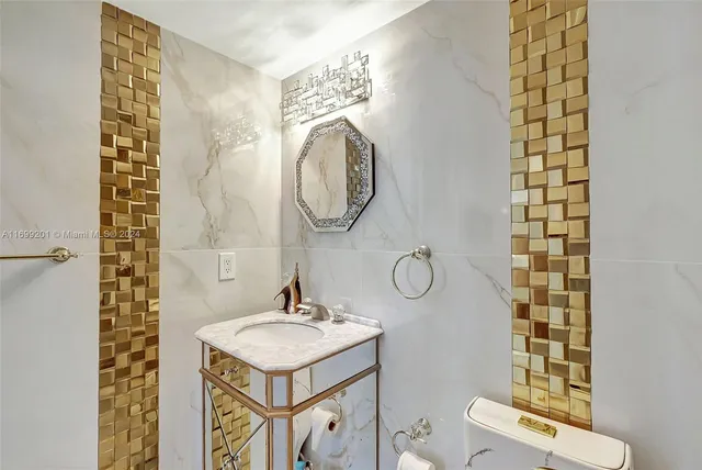 a bathroom with a sink mirror and toilet