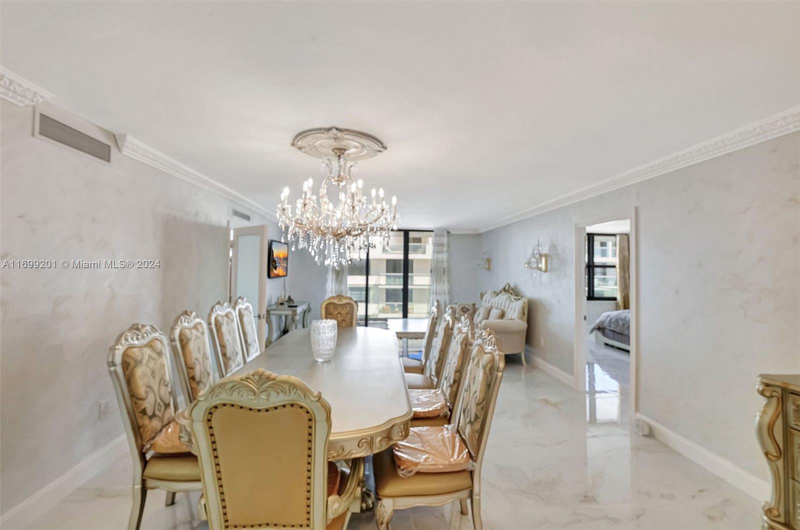 9801 Collins Avenue, Unit 20T Bal Harbour, FL 33154 - Photo 2 of 23 a view of a dining room with furniture and chandelier