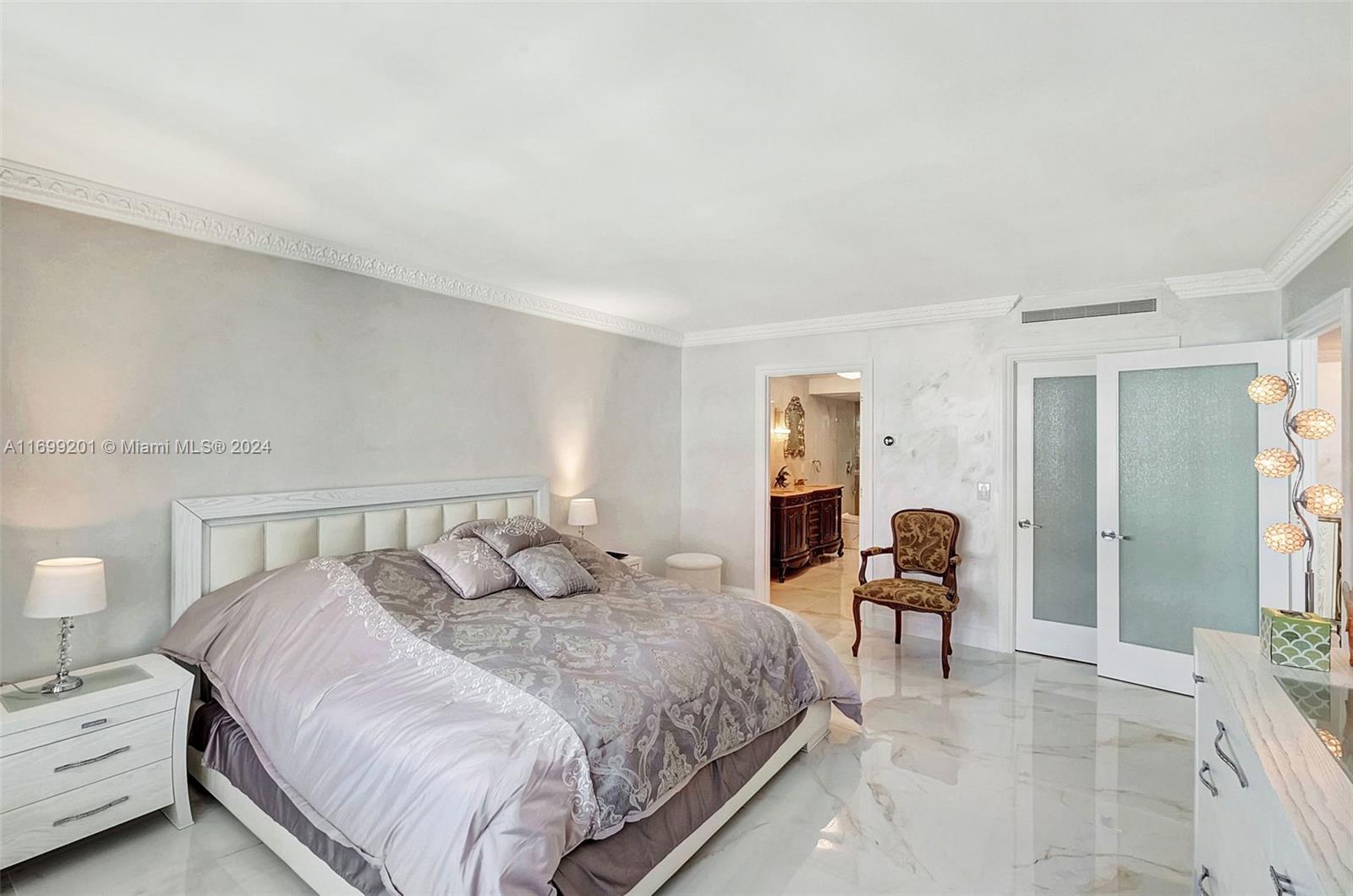 9801 Collins Avenue, Unit 20T Bal Harbour, FL 33154 - Photo 22 of 23 a bedroom with a bed and lamp