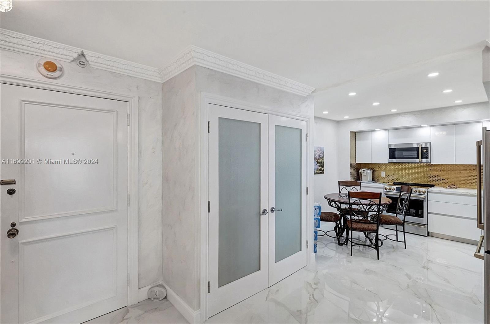 9801 Collins Avenue, Unit 20T Bal Harbour, FL 33154 - Photo 4 of 23 a view of a livingroom with furniture and a window