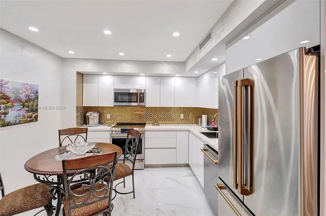 a kitchen with a sink appliances and cabinets