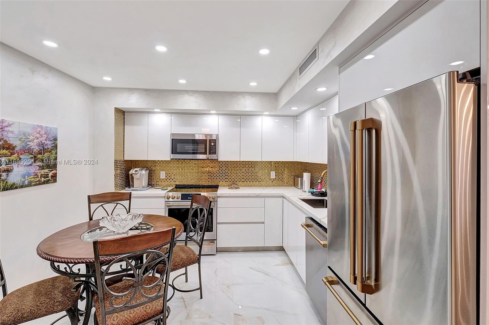9801 Collins Avenue, Unit 20T Bal Harbour, FL 33154 - Photo 5 of 23 a kitchen with a sink appliances and cabinets