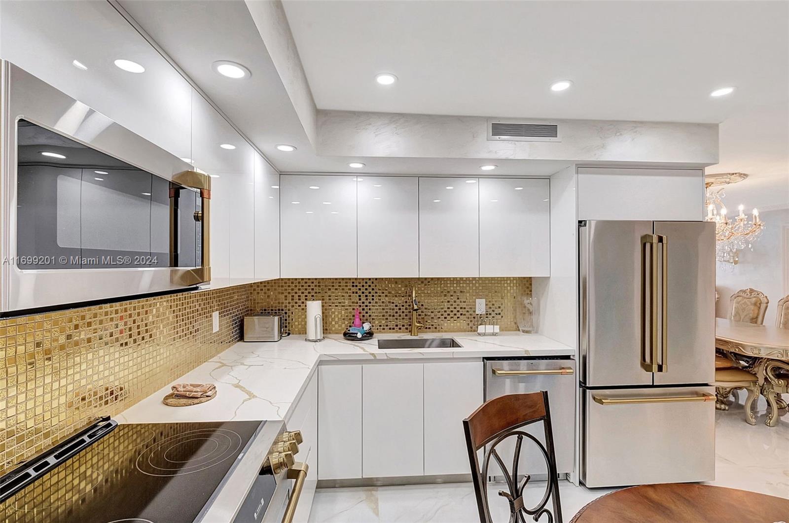 9801 Collins Avenue, Unit 20T Bal Harbour, FL 33154 - Photo 6 of 23 a kitchen with a refrigerator and a microwave