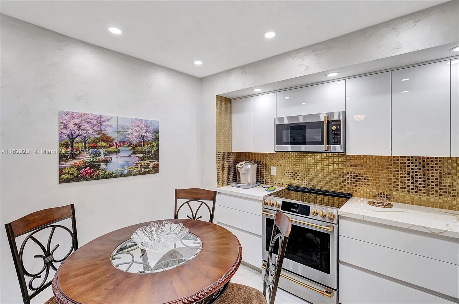 9801 Collins Avenue, Unit 20T Bal Harbour, FL 33154 - Photo 7 of 23 a kitchen with a table and chairs