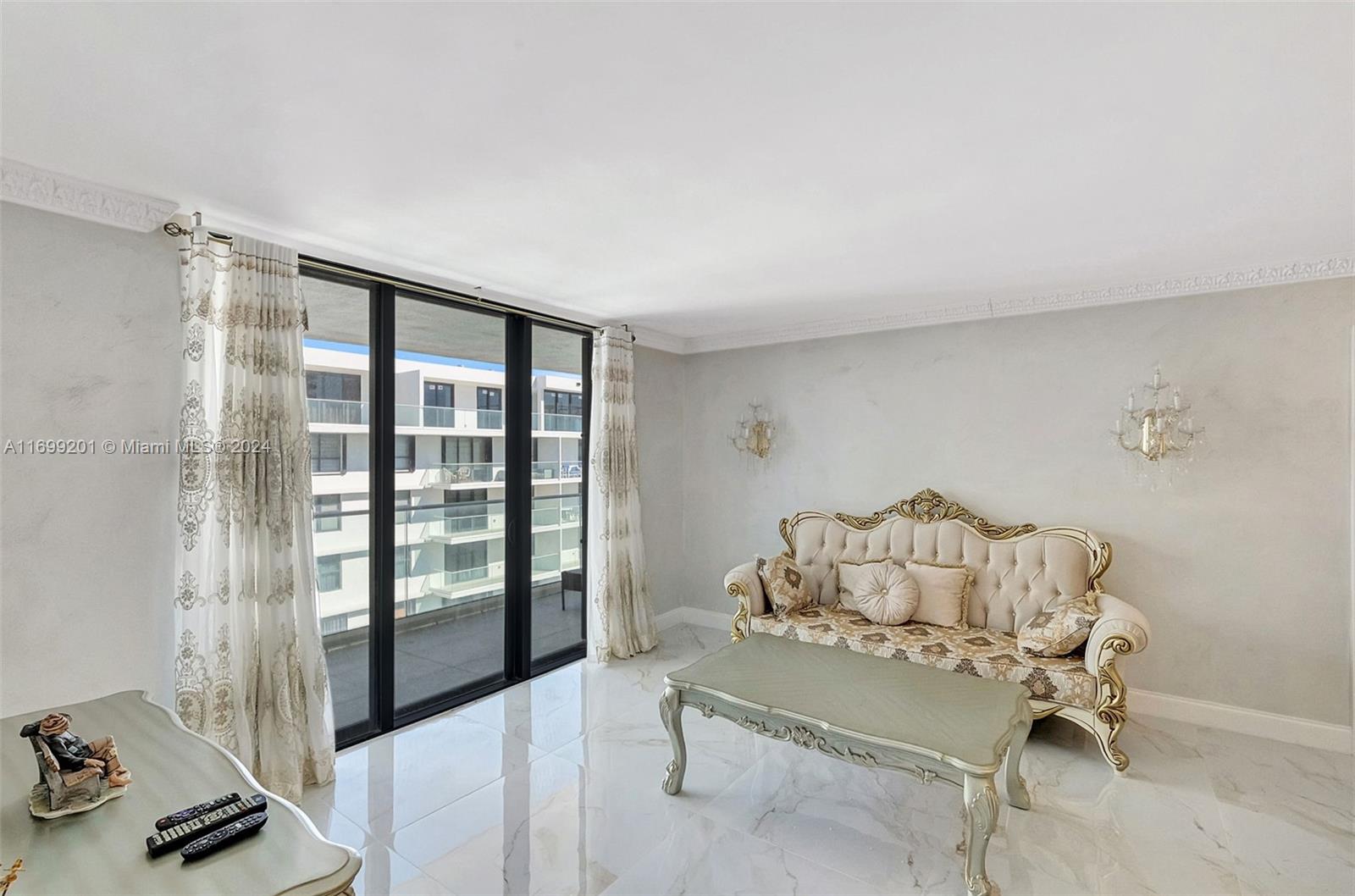 9801 Collins Avenue, Unit 20T Bal Harbour, FL 33154 - Photo 8 of 23 a living room with furniture and a window