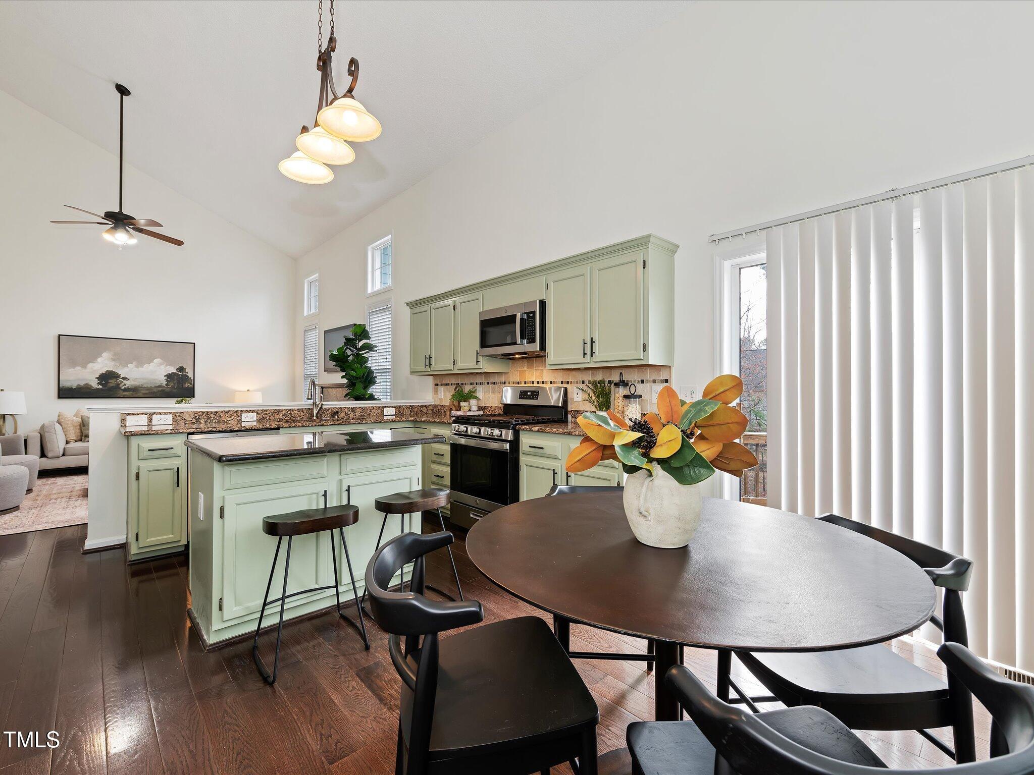 104 Deep Gap Run Cary, NC 27519 - Photo 9 of 39 a kitchen with a dining table chairs and microwave