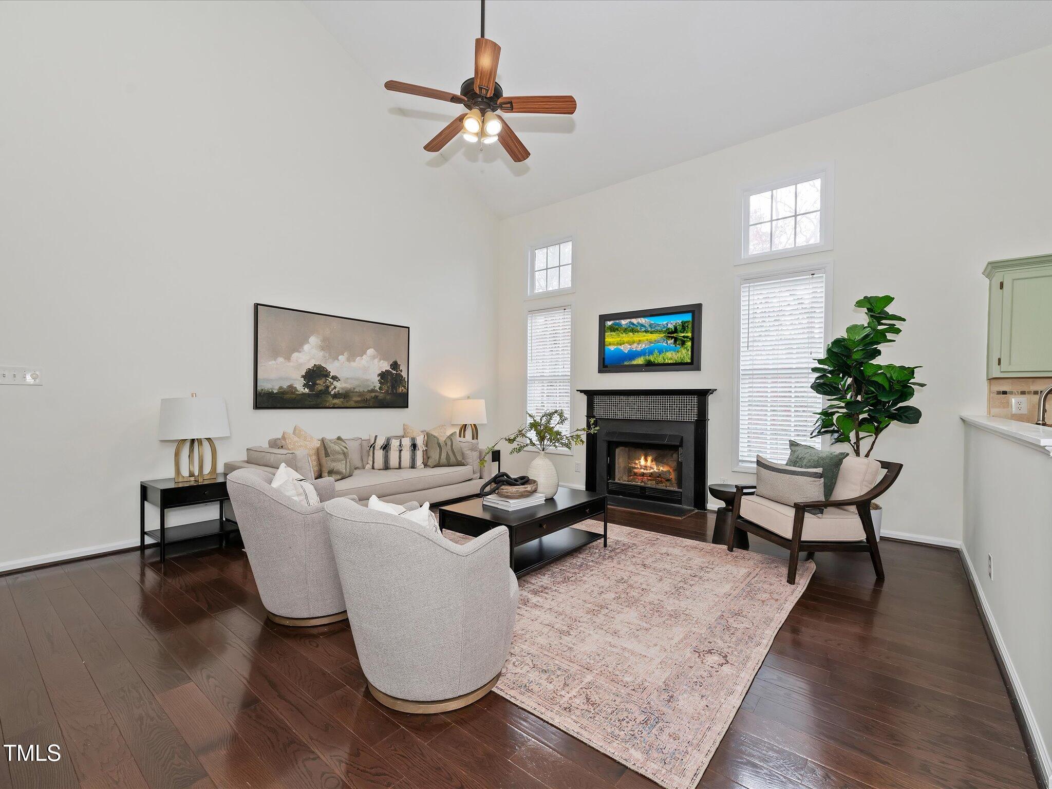 104 Deep Gap Run Cary, NC 27519 - Photo 11 of 39 a living room with furniture a fireplace and a potted plant