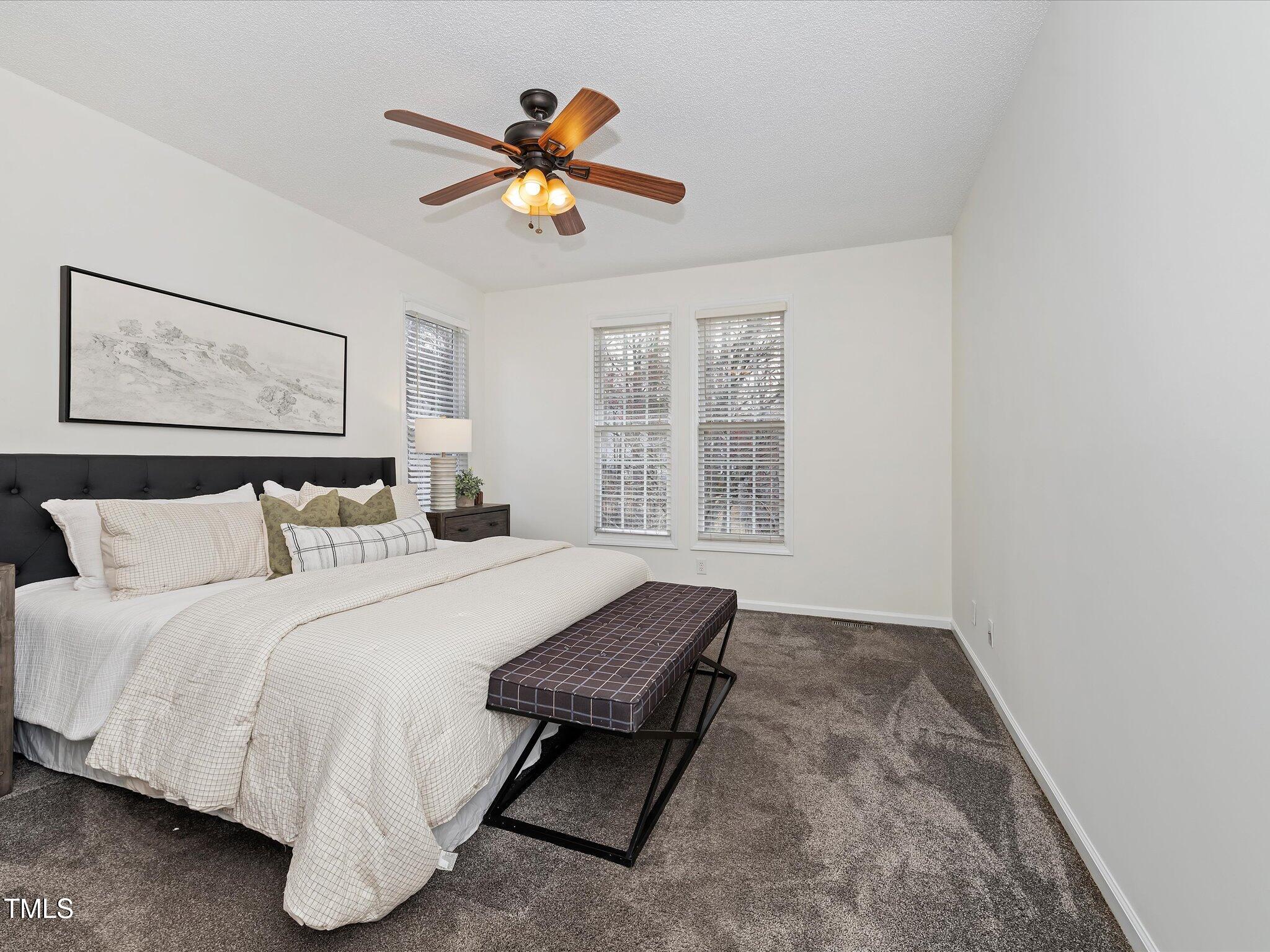 104 Deep Gap Run Cary, NC 27519 - Photo 13 of 39 a bedroom with a large bed and a window