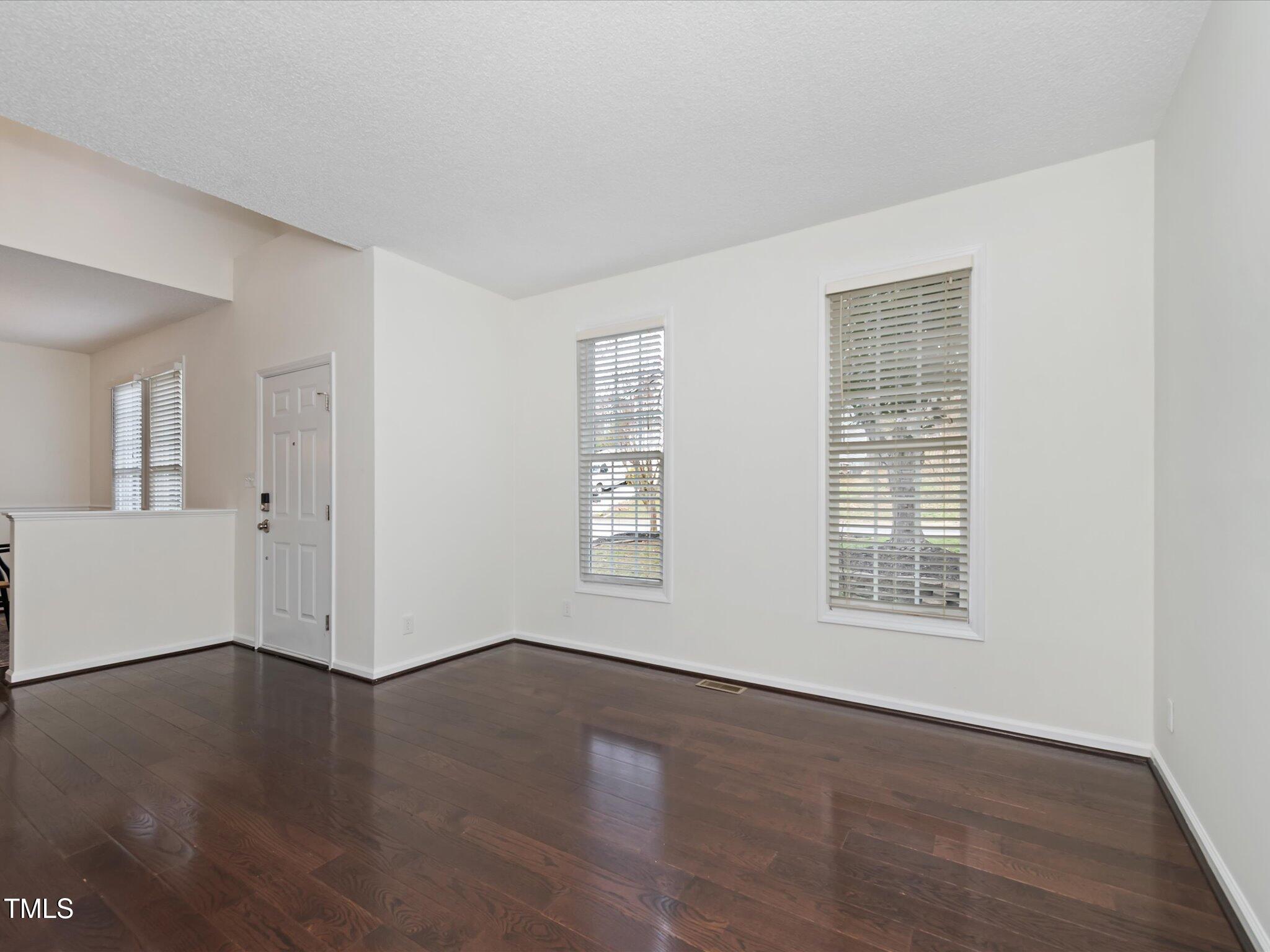 104 Deep Gap Run Cary, NC 27519 - Photo 18 of 39 a view of an empty room with wooden floor and a window