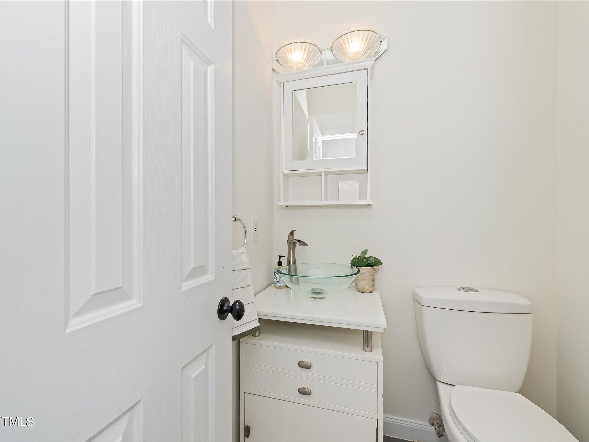 104 Deep Gap Run Cary, NC 27519 - Photo 26 of 39 a bathroom with a sink a toilet and mirror