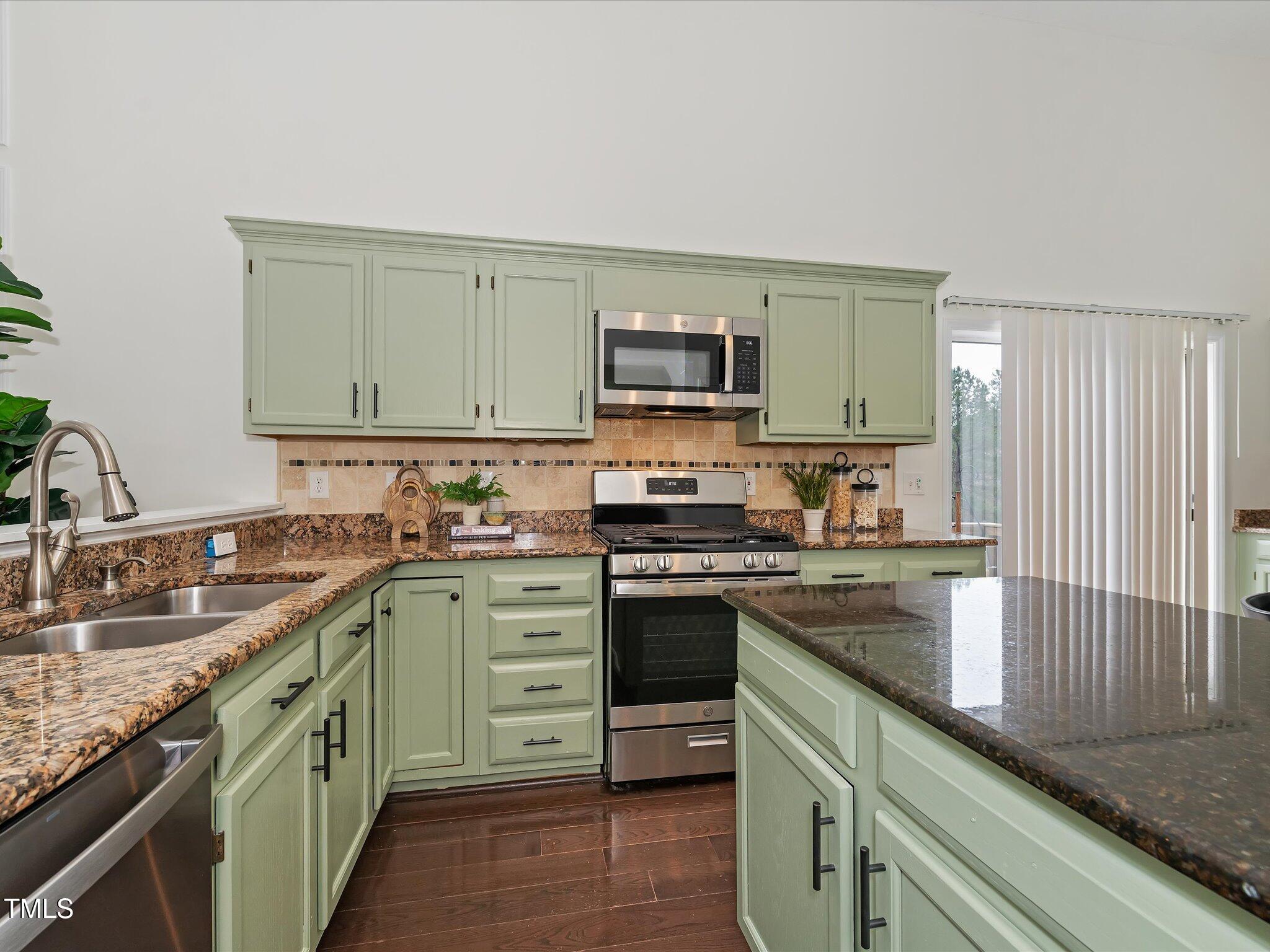104 Deep Gap Run Cary, NC 27519 - Photo 7 of 39 a kitchen with stainless steel appliances granite countertop a sink stove and refrigerator
