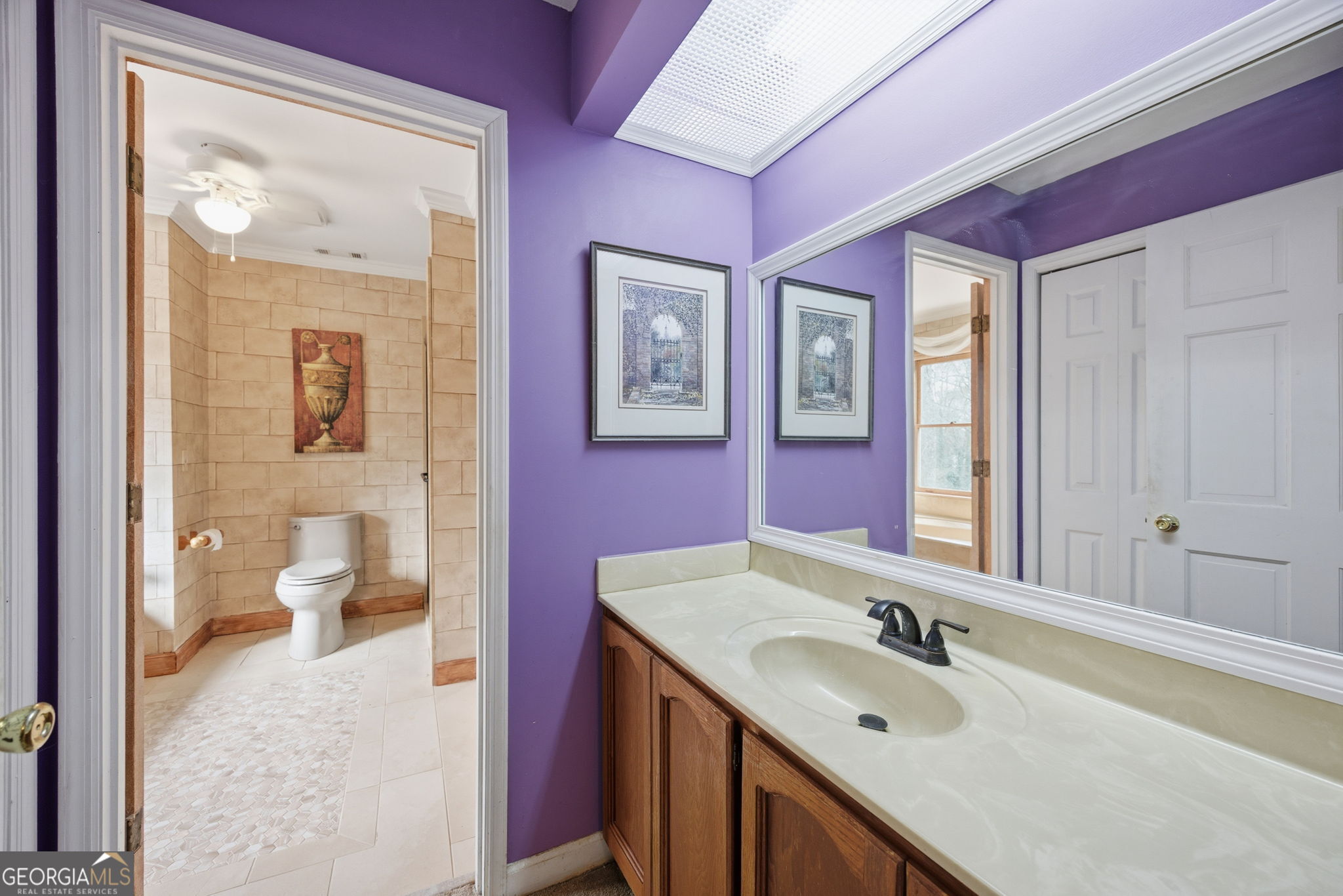 1391 Briarcliff Road, Unit 4B Macon, GA 31211 - Photo 31 of 42 a bathroom with a granite countertop double vanity sink a mirror and a toilet
