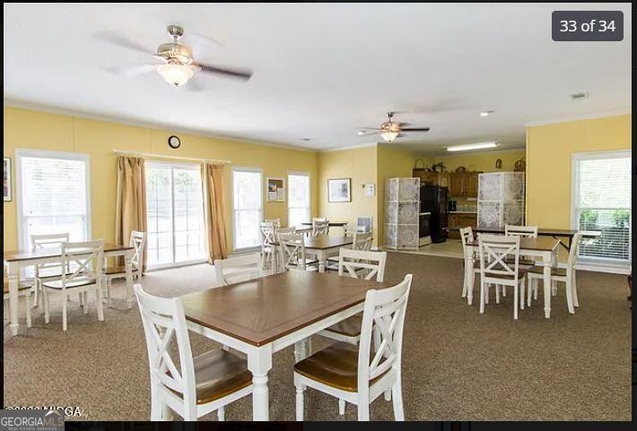 1391 Briarcliff Road, Unit 4B Macon, GA 31211 - Photo 40 of 42 a dining hall with stainless steel appliances granite countertop a dining table and chairs