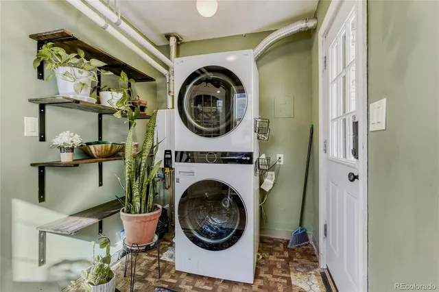 a view of hallway with wooden floor and chandelier