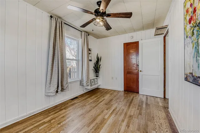 a view of an empty room with window and cabinet