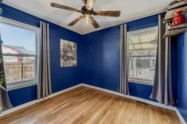 a bedroom with furniture book shelves and a window