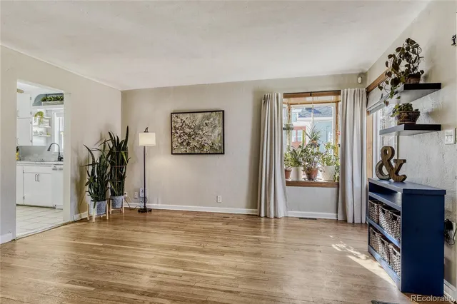a view of a livingroom with a workspace and bathroom