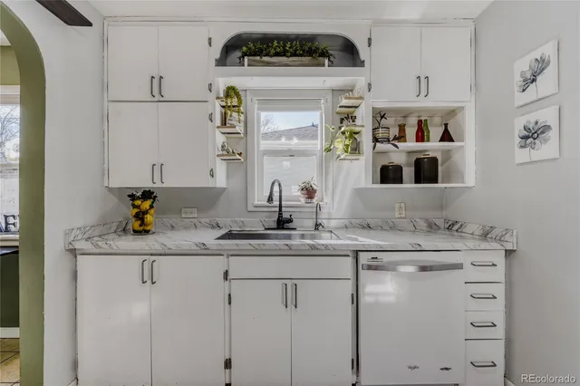 a kitchen with cabinets and window