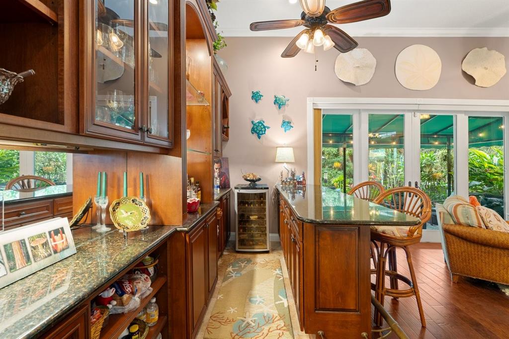 4606 Oak Hammock Court, Unit 4606 Ponce Inlet, FL 32127 - Photo 22 of 92 a view of a dining room with furniture a chandelier and wooden floor