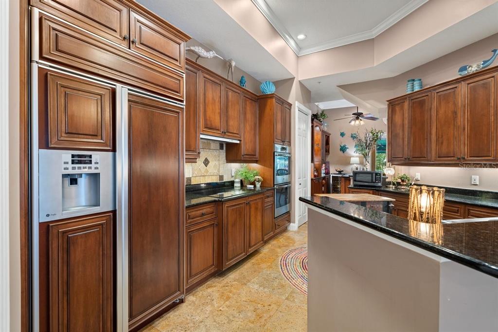 4606 Oak Hammock Court, Unit 4606 Ponce Inlet, FL 32127 - Photo 27 of 92 a kitchen with stainless steel appliances granite countertop a refrigerator and a sink