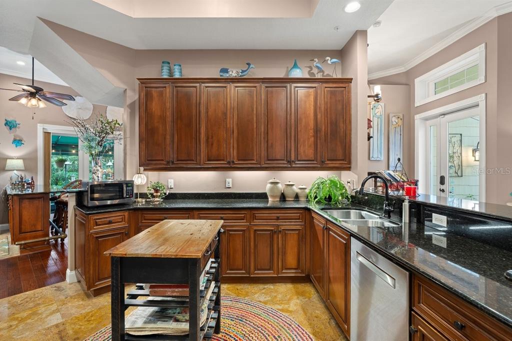 4606 Oak Hammock Court, Unit 4606 Ponce Inlet, FL 32127 - Photo 28 of 92 a kitchen with granite countertop a sink a counter space appliances and cabinets