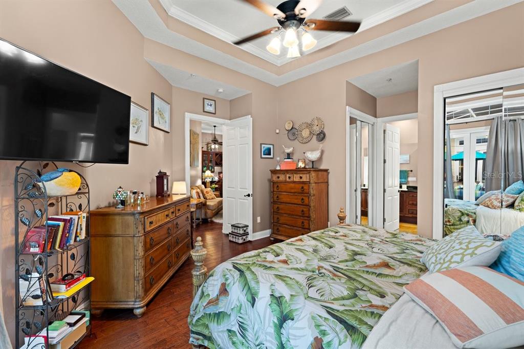 4606 Oak Hammock Court, Unit 4606 Ponce Inlet, FL 32127 - Photo 34 of 92 a bedroom with a bed and flat screen tv