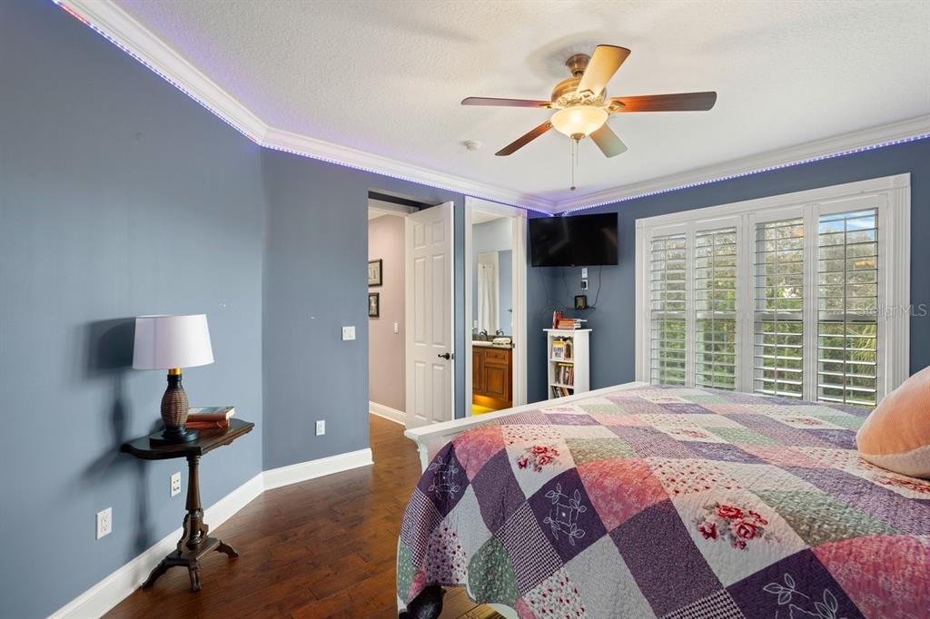 4606 Oak Hammock Court, Unit 4606 Ponce Inlet, FL 32127 - Photo 43 of 92 a bed room with a bed and a chandelier