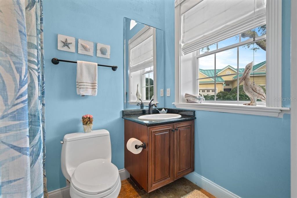 4606 Oak Hammock Court, Unit 4606 Ponce Inlet, FL 32127 - Photo 9 of 92 a bathroom with a toilet a sink and a window