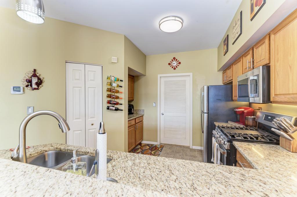 8321 Ripple Ridge Darien, IL 60561 - Photo 12 of 27 a kitchen with stainless steel appliances granite countertop a refrigerator and a stove top oven