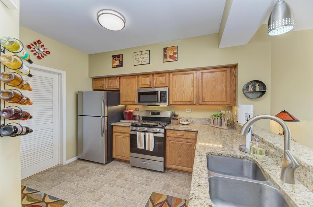8321 Ripple Ridge Darien, IL 60561 - Photo 13 of 27 a kitchen with a refrigerator and a sink