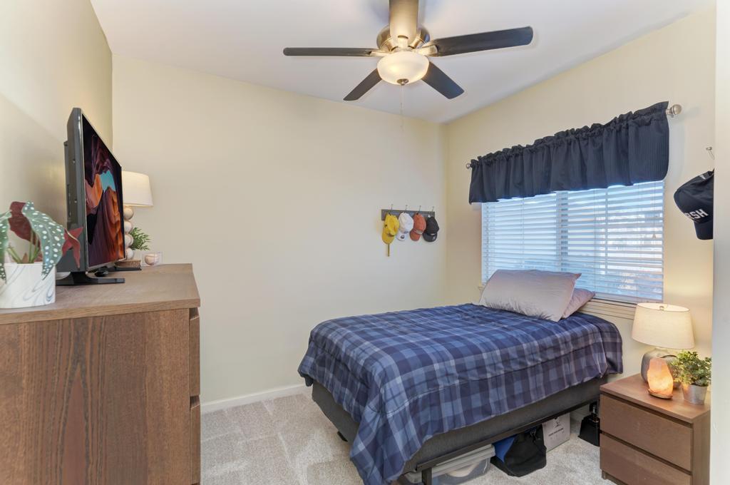 8321 Ripple Ridge Darien, IL 60561 - Photo 21 of 27 a bedroom with a bed and a flat screen tv